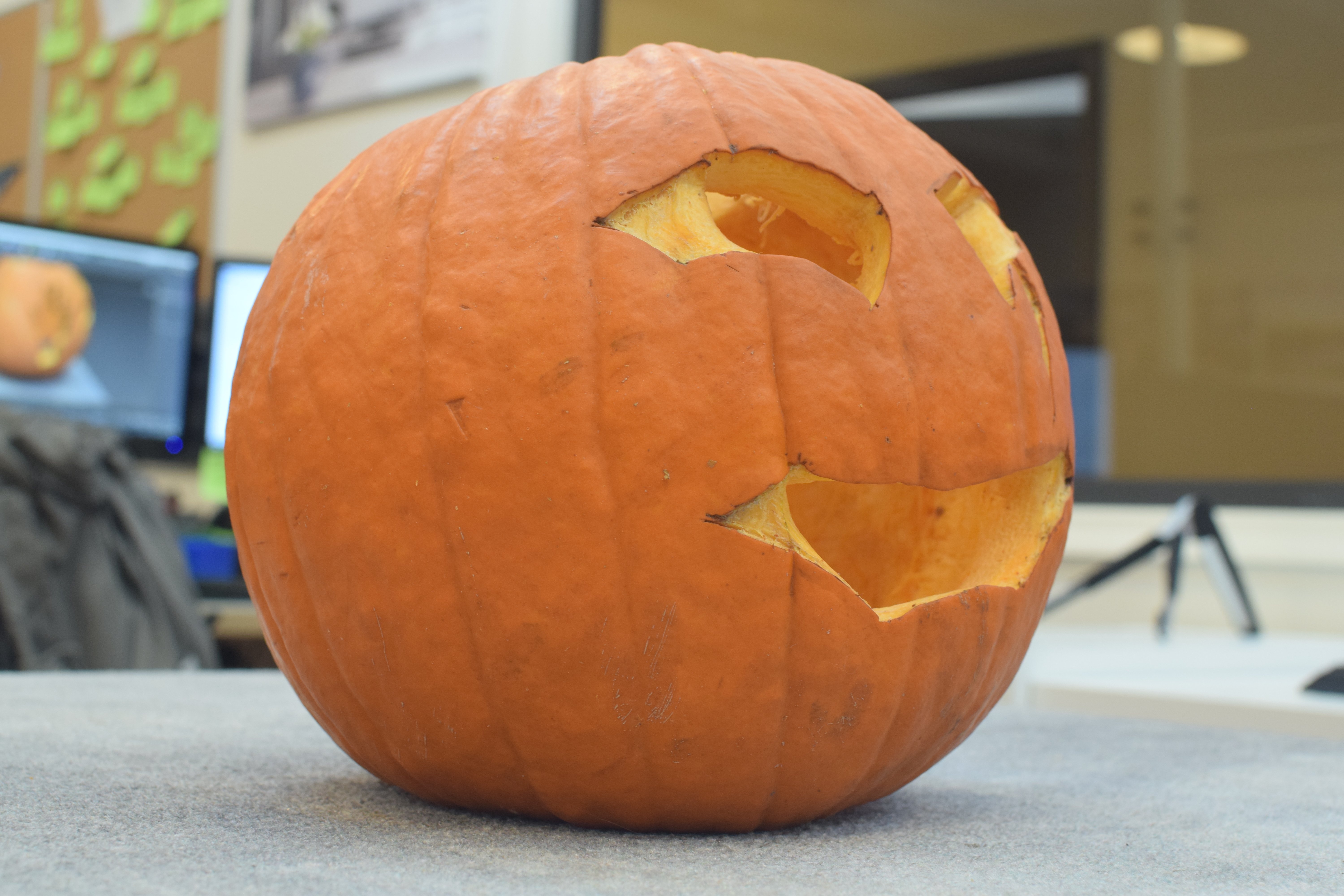 Close up of a carved pumpkin being photographed