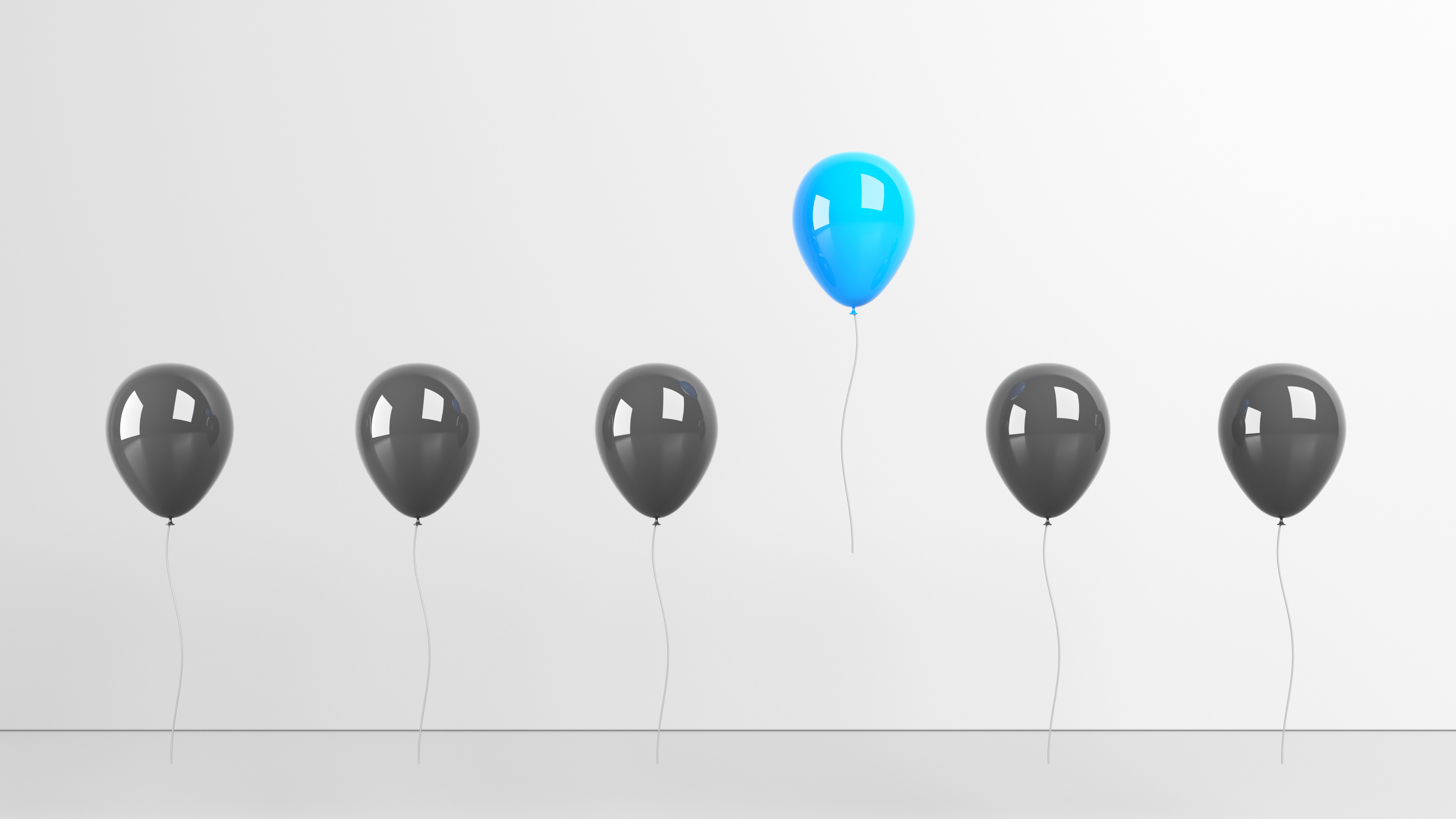 Solo blue balloon stands out from the other black balloons