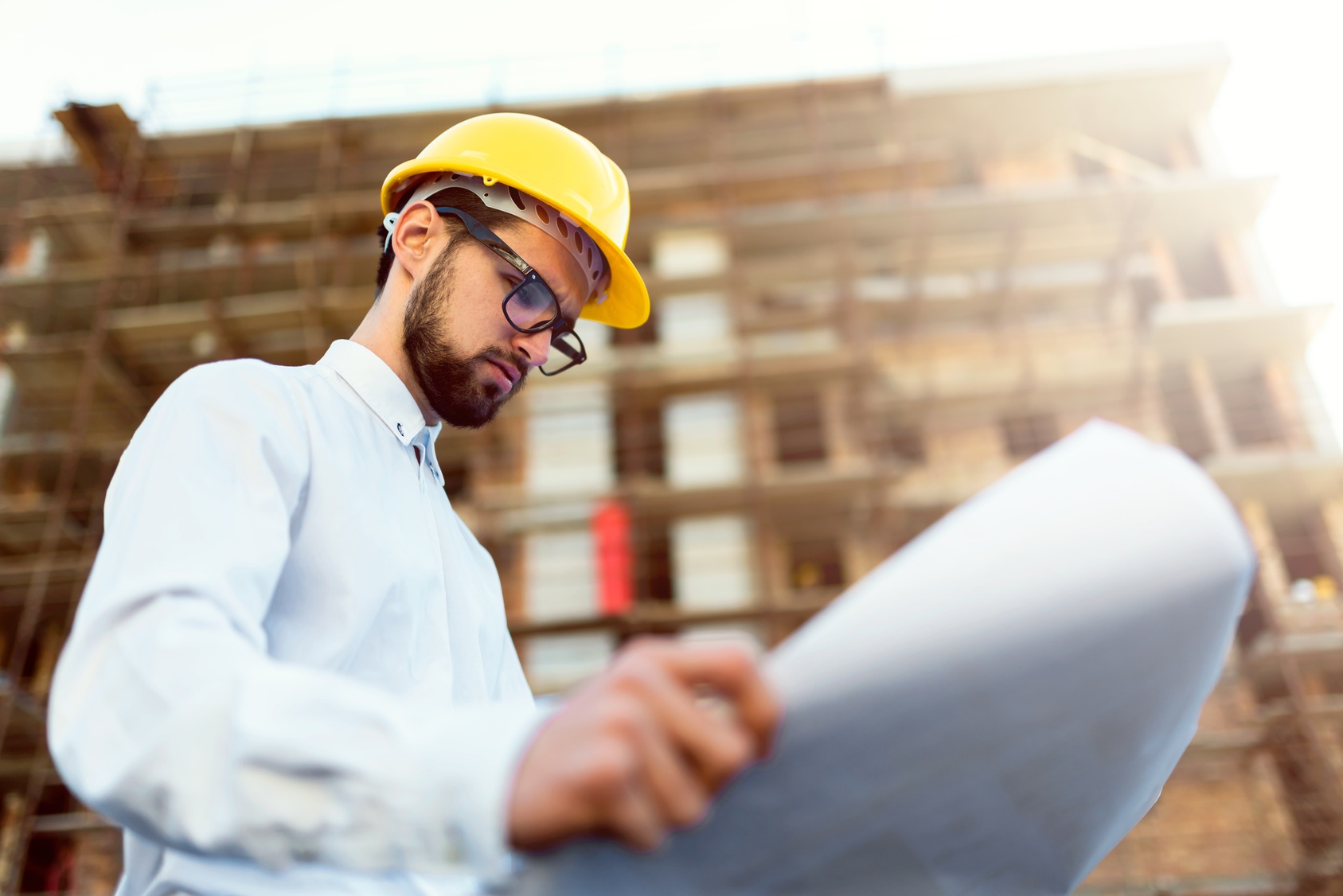 Construction worker on site with drawings